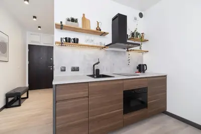 a kitchen with a sink and a stove at Studio apartment - Rakowicka 14 Street in Kraków