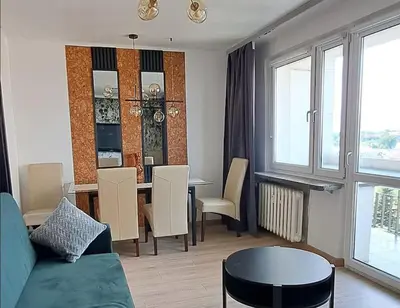 two beds in a room with a window at Green apartament 2 in Oświęcim