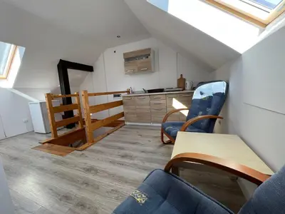 a room with a table and chairs and a kitchen at Domek Olivia na Wyłączność in Wola Kalinowska
