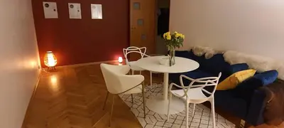 a living room with a table and chairs and a couch at Coco Chanel Cosy 45 m2 city centre fast wifi in Kraków