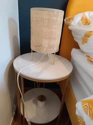 a chair sitting on a table next to a bed at Coco Chanel Cosy 45 m2 city centre fast wifi in Kraków