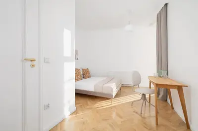 a room with a bed and a table and a chair at Apartment - Plac Wolnica 12A in Kraków