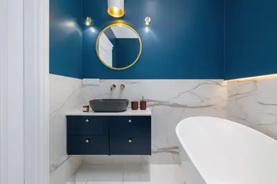 a blue bathroom with a sink and a mirror at Apartment - Plac Wolnica 12A in Kraków