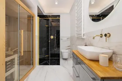 a white bathroom with a sink and a shower at Apartment - Plac Wolnica 12A in Kraków