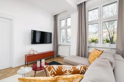 a living room with a couch and a tv at Apartment - Plac Wolnica 12A in Kraków