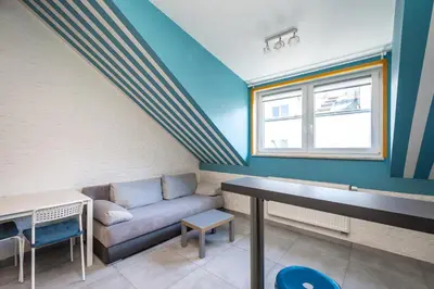 a living room with a couch and a table at RentPlanet - Apartament Ariańska in Kraków