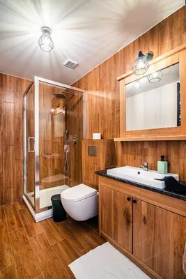 a bathroom with a toilet and a sink and a shower at Dom z bali - Serafinówka in Tęgoborze