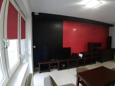 a living room with a red and black wall at Apartament Kantego in Olkusz