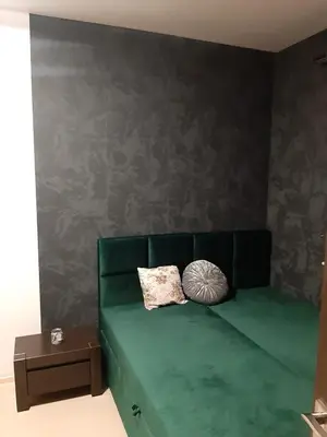 a green couch with two pillows in a room at Apartament Kantego in Olkusz