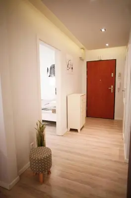 a hallway with a door and a room with a bed at Komfortowy Apartament Bociana 4 in Kraków