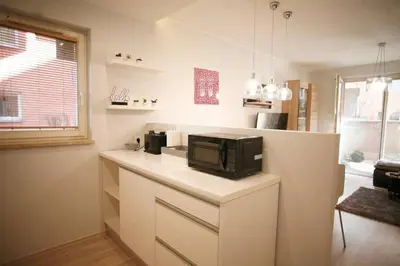 a kitchen with a counter with a microwave on it at Komfortowy Apartament Bociana 4 in Kraków