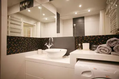 a white bathroom with a sink and a mirror at Komfortowy Apartament Bociana 4 in Kraków