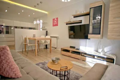 a living room with a couch and a table at Komfortowy Apartament Bociana 4 in Kraków