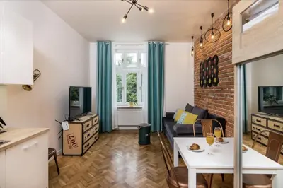 a living room with a couch and a table at Studio apartment - Centre of Kraków - Starowiślna 54 in Kraków