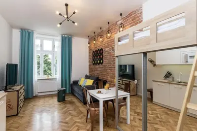 a living room with a couch and a table at Studio apartment - Centre of Kraków - Starowiślna 54 in Kraków