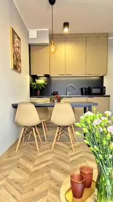 a kitchen with two chairs and a kitchen counter at Sunshine by Housine in Zator