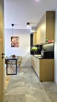 a kitchen with a table and a dining room at Sunshine by Housine in Zator