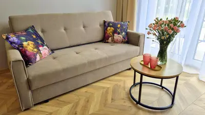 a living room with a couch and a table with flowers at Sunshine by Housine in Zator