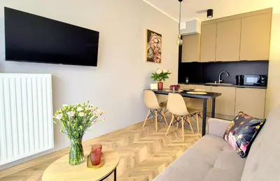 a living room with a couch and a table at Sunshine by Housine in Zator