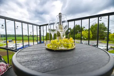 a bowl of lemons and wine glasses on a table at Sunshine by Housine in Zator