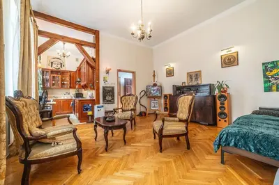 a bedroom with a bed and chairs and a table at Climatic studio for 2-4 person in Main Square in Kraków