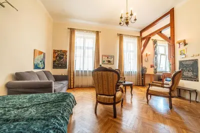 a living room with a couch and a table and chairs at Climatic studio for 2-4 person in Main Square in Kraków