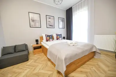 a bedroom with a bed and a chair in it at Sunset by Housine in Zator