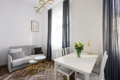 a living room with a white table and a couch at Native Apartments Smoleńsk 33 in Kraków