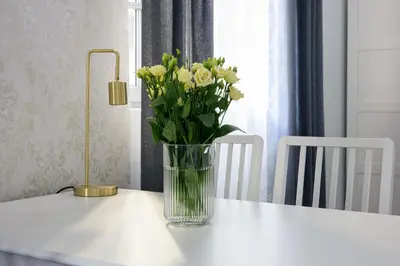 a vase of flowers sitting on top of a table at Native Apartments Smoleńsk 33 in Kraków