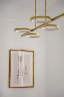 a picture of a man on a wall with a chandelier at Native Apartments Smoleńsk 33 in Kraków