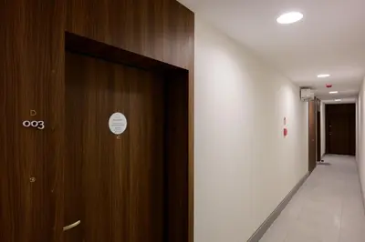 a hallway with a wooden door in a building at Native Apartments Smoleńsk 33 in Kraków