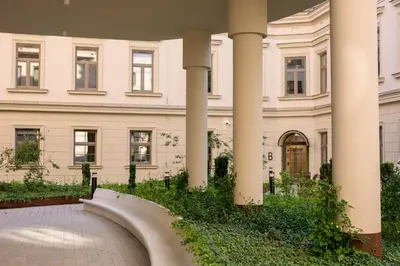 a building with columns and a walkway in front at Native Apartments Smoleńsk 33 in Kraków