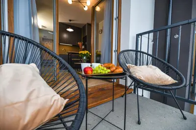 a table with a plate of fruit on a balcony at Moonlight by Housine in Zator