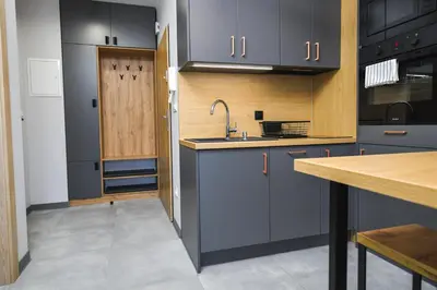 a kitchen with blue cabinets and a sink at Moonlight by Housine in Zator