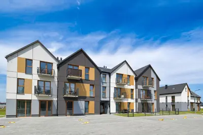 a row of apartment buildings in a parking lot at Moonlight by Housine in Zator