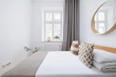 a bedroom with a large white bed with a mirror at Wielopole 7 - 1 bedroom - OLD TOWN in Kraków