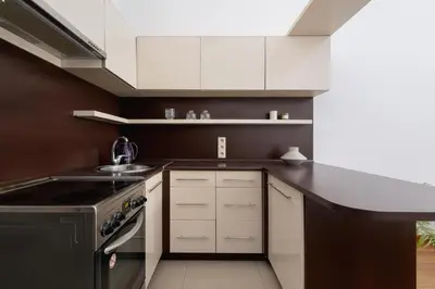 a kitchen with white cabinets and a black stove at Wielopole 7 - 1 bedroom - OLD TOWN in Kraków