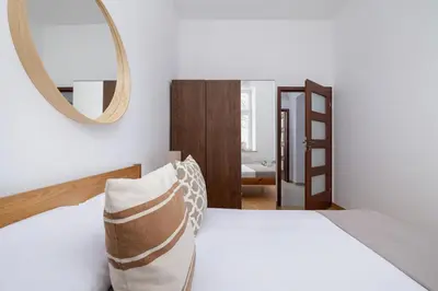 a bedroom with a white bed and a mirror at Wielopole 7 - 1 bedroom - OLD TOWN in Kraków