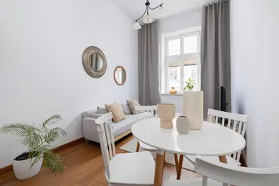 a white living room with a white table and chairs at Wielopole 7 - 1 bedroom - OLD TOWN in Kraków