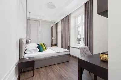 a bedroom with a bed and a desk and a table at Apartment with balcony - Kazimierz- Starowislna 43 in Kraków