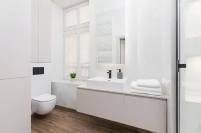 a white bathroom with a toilet and a sink at Apartment with balcony - Kazimierz- Starowislna 43 in Kraków