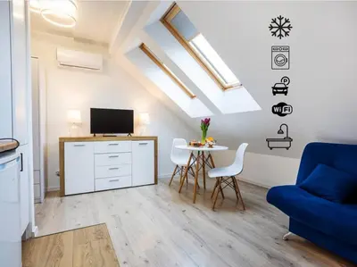 a living room with a blue couch and a table at Apartment Close to the Center in Kraków