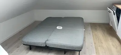 a bed sitting on the floor in a room at Apartment Close to the Center in Kraków
