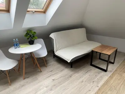 a small room with a chair and a table at Apartment Close to the Center in Kraków