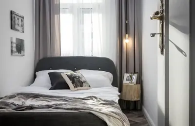 a bedroom with a bed with pillows and a window at Jozefa 20 Street 2 bedroom apartment in Kraków