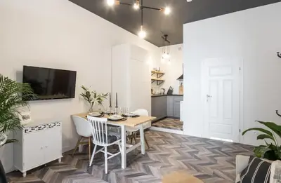 a kitchen and dining room with a table and chairs at Jozefa 20 Street 2 bedroom apartment in Kraków