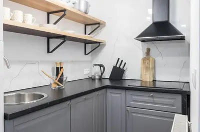 a kitchen with a sink and a counter top at Jozefa 20 Street 2 bedroom apartment in Kraków