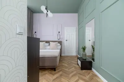 a bedroom with a bed and a mirror at 3 Bedroom Apartment - Dietla 11 in Kraków