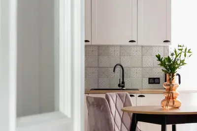 a kitchen with a table and a sink at 3 Bedroom Apartment - Dietla 11 in Kraków