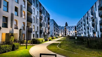 a walkway in a city with tall buildings at Lema Tauron Arena Two Bedroom Apartment in Kraków